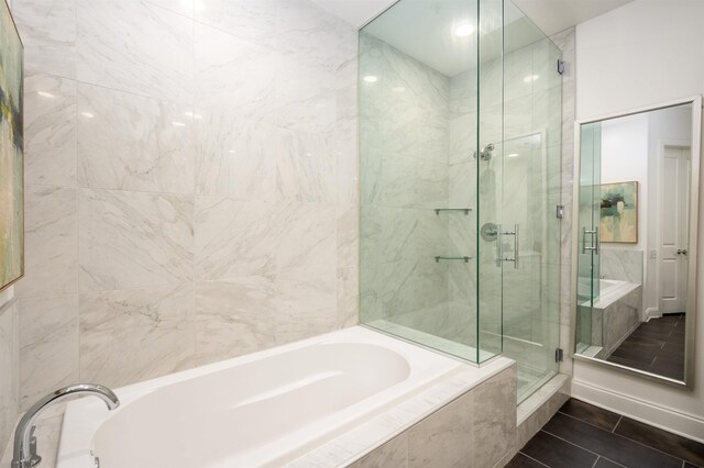 717 S Riverside Dr Unit 1203, Memphis, TN 38103 - bathroom featuring a stall shower, a garden tub, and tile patterned floors