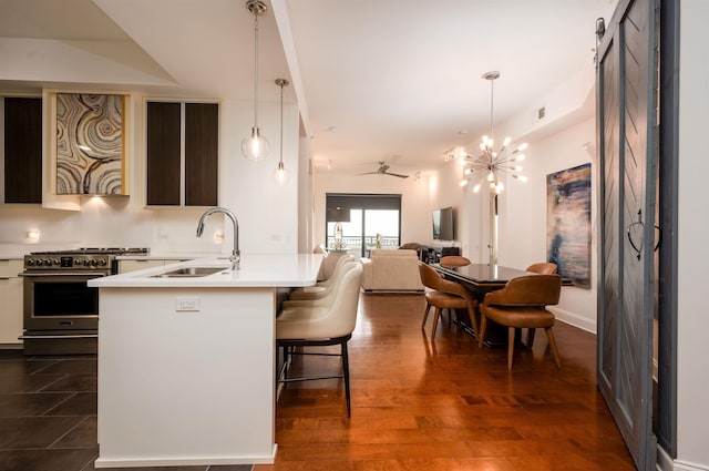 717 S Riverside Dr Unit 1203, Memphis, TN 38103 - kitchen featuring a sink, high end stainless steel range, light countertops, a kitchen bar, and open floor plan