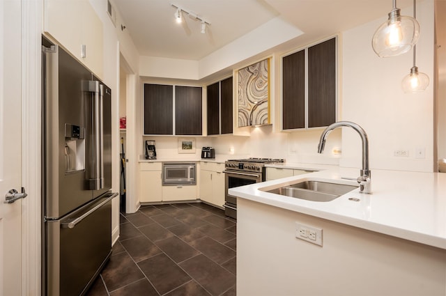 717 S Riverside Dr Unit 1203, Memphis, TN 38103 - kitchen with high end appliances, a sink, light countertops, dark tile patterned floors, and decorative light fixtures