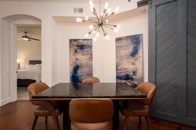 717 S Riverside Dr Unit 1203, Memphis, TN 38103 - dining space featuring arched walkways, dark wood-style flooring, a chandelier, a barn door, and a ceiling fan