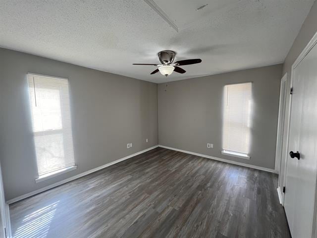 2151 Ptarmigan Trl, Memphis, TN 38134 - empty room with dark wood-type flooring, ceiling fan, baseboards, and a textured ceiling