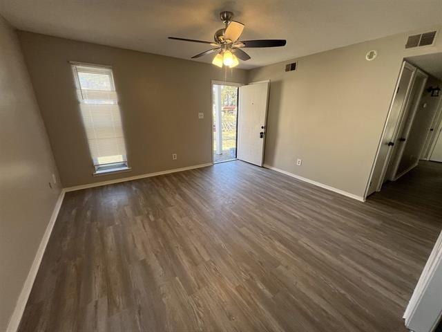 2151 Ptarmigan Trl, Memphis, TN 38134 - empty room featuring dark wood finished floors, healthy amount of natural light, and a ceiling fan