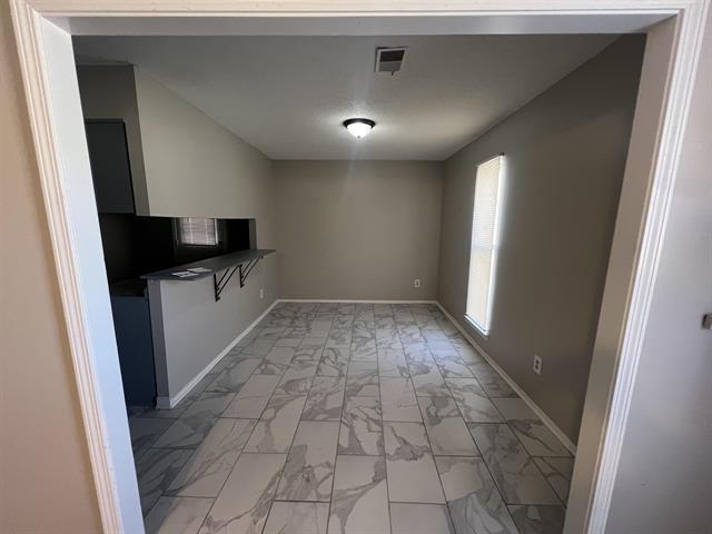 2151 Ptarmigan Trl, Memphis, TN 38134 - unfurnished dining area with light marble finish floors and baseboards