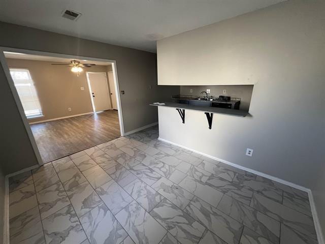 2151 Ptarmigan Trl, Memphis, TN 38134 - unfurnished room with baseboards, marble finish flooring, a ceiling fan, and a sink