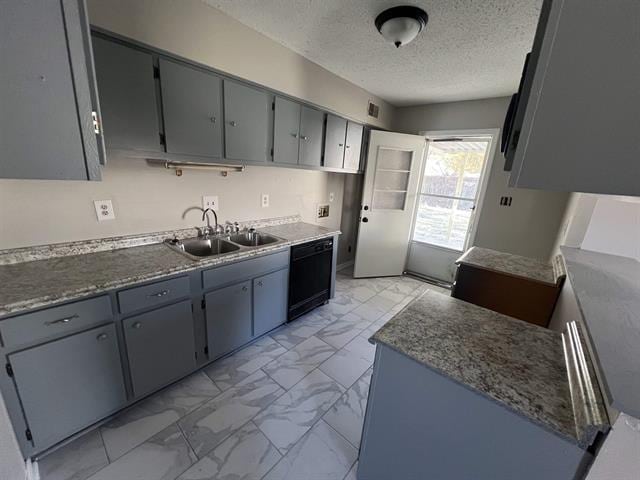 2151 Ptarmigan Trl, Memphis, TN 38134 - kitchen featuring a sink, light marble finish floors, black dishwasher, a textured ceiling, and gray cabinets