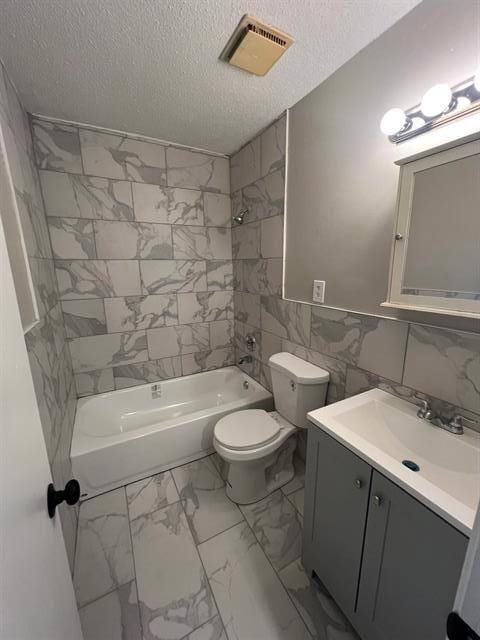 2151 Ptarmigan Trl, Memphis, TN 38134 - bathroom with marble look tiles, a textured ceiling, toilet, tub / shower combination, and vanity