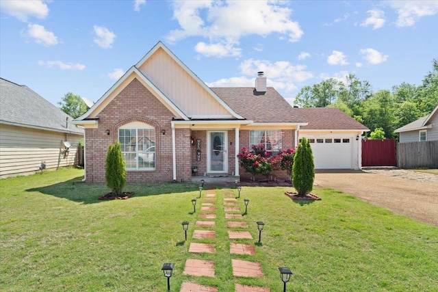 2518 Bassfield Dr, Memphis, TN 38133 - view of front facade with driveway, brick siding, a chimney, and a garage