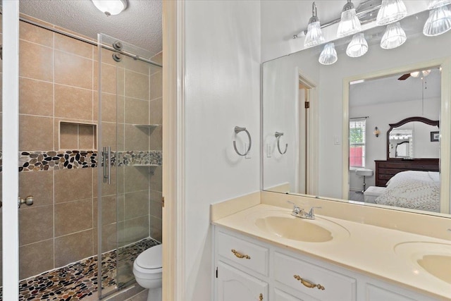 2518 Bassfield Dr, Memphis, TN 38133 - ensuite bathroom with a shower stall, double vanity, toilet, and a textured ceiling