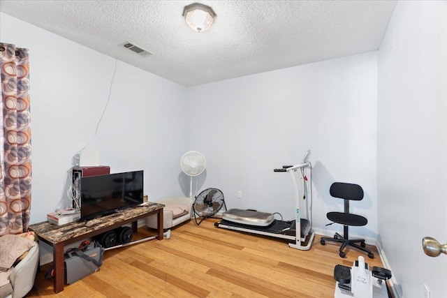2518 Bassfield Dr, Memphis, TN 38133 - exercise area featuring light wood-type flooring and a textured ceiling