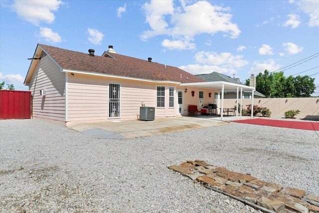 2518 Bassfield Dr, Memphis, TN 38133 - back of house with a patio, a fenced backyard, central AC unit, and a chimney