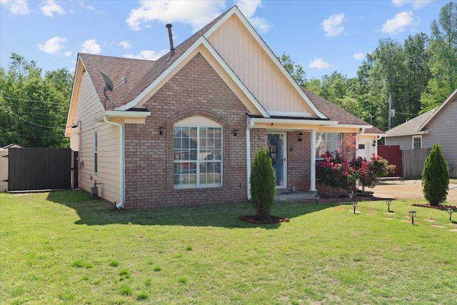 2518 Bassfield Dr, Memphis, TN 38133 - view of front of house with brick siding, board and batten siding, a garage, roof with shingles, and a gate