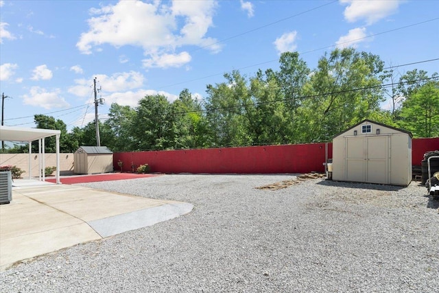 2518 Bassfield Dr, Memphis, TN 38133 - fenced backyard featuring a storage unit, an outdoor structure, central AC unit, and a patio