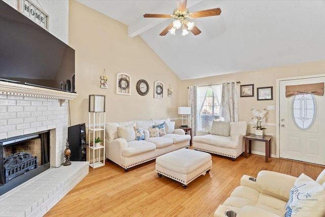 2518 Bassfield Dr, Memphis, TN 38133 - living room with beamed ceiling, high vaulted ceiling, a ceiling fan, hardwood / wood-style flooring, and a brick fireplace