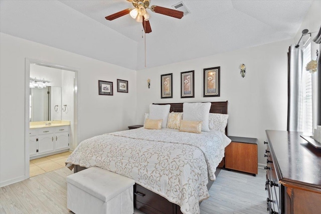 2518 Bassfield Dr, Memphis, TN 38133 - bedroom with light wood-type flooring, lofted ceiling, baseboards, ceiling fan, and ensuite bathroom