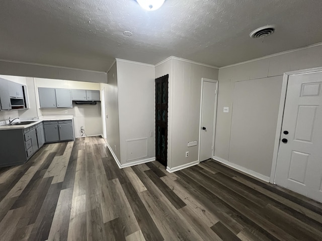 1684 Walter St, Memphis, TN 38108 - unfurnished living room with ornamental molding, a textured ceiling, dark wood-style floors, and a sink