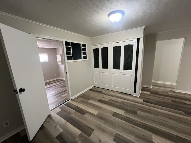 1684 Walter St, Memphis, TN 38108 - unfurnished bedroom with a textured ceiling, baseboards, wood finished floors, a closet, and crown molding