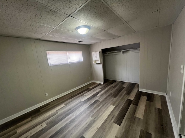 1684 Walter St, Memphis, TN 38108 - unfurnished bedroom featuring a paneled ceiling, dark wood-style flooring, baseboards, and a closet