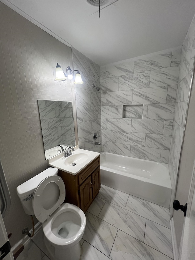 1684 Walter St, Memphis, TN 38108 - bathroom featuring marble look tiles, bathtub / shower combination, vanity, and toilet