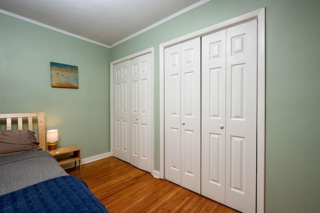 4152 Barfield Rd, Memphis, TN 38117 - bedroom with wood finished floors, two closets, baseboards, and ornamental molding