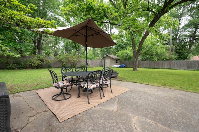 4152 Barfield Rd, Memphis, TN 38117 - view of patio featuring outdoor dining space, a shed, an outdoor structure, and view of scattered trees