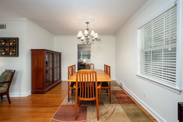4152 Barfield Rd, Memphis, TN 38117 - dining space featuring a chandelier, wood finished floors, healthy amount of natural light, ornamental molding, and baseboards