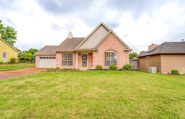 6686 Elmore Ridge Ln, Memphis, TN 38134 - view of front of property with brick siding, board and batten siding, driveway, central air condition unit, and a front lawn