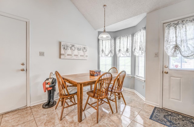 6686 Elmore Ridge Ln, Memphis, TN 38134 - dining space featuring a textured ceiling, light tile patterned floors, lofted ceiling, and baseboards