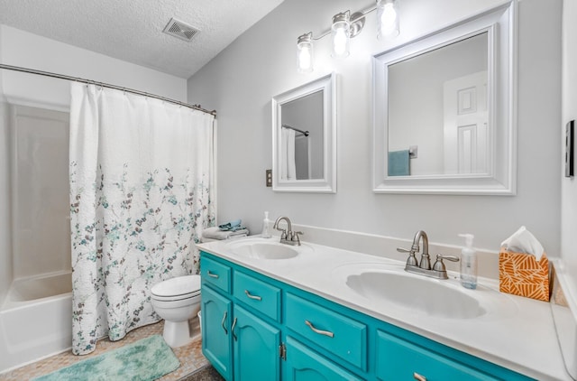6686 Elmore Ridge Ln, Memphis, TN 38134 - bathroom featuring a textured ceiling, toilet, double vanity, shower / bath combo with shower curtain, and tile patterned floors