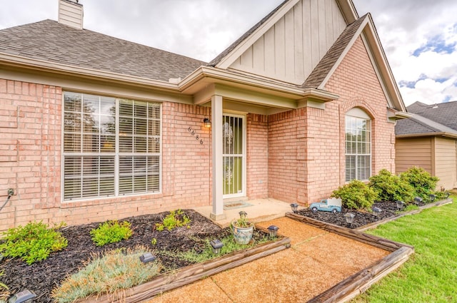 6686 Elmore Ridge Ln, Memphis, TN 38134 - entrance to property featuring brick siding, board and batten siding, roof with shingles, and a chimney