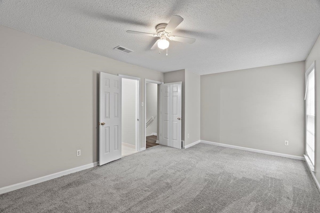 5544 Blossom Ln, Memphis, TN 38115 - unfurnished bedroom with a textured ceiling, carpet flooring, baseboards, and a ceiling fan