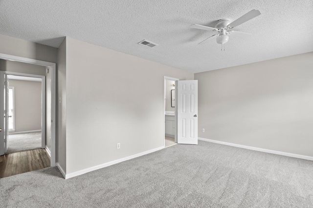 5544 Blossom Ln, Memphis, TN 38115 - unfurnished bedroom featuring carpet, baseboards, a textured ceiling, ensuite bathroom, and ceiling fan