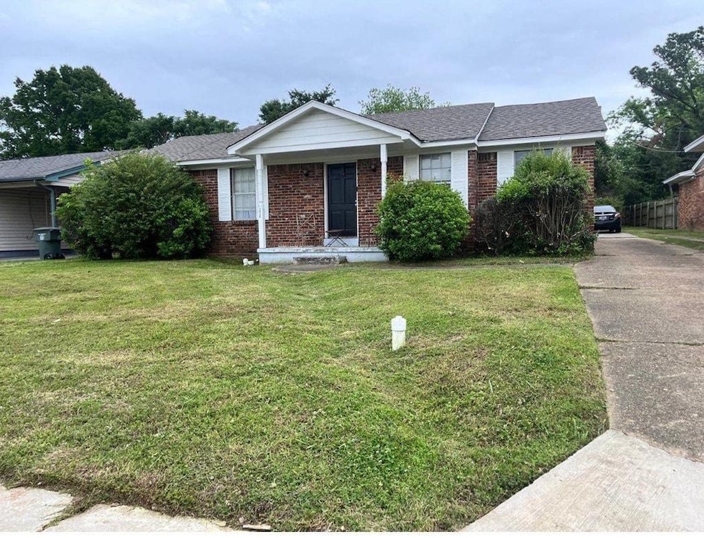 2428 Rozelle St, Memphis, TN 38114 - single story home with brick siding, a front yard, and driveway