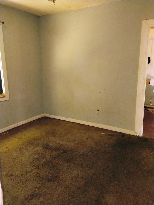 spare room with carpet flooring and baseboards