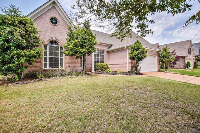 1563 Sutton Meadow Ln, Cordova, TN 38016 - view of front of home with brick siding, a garage, a front yard, and driveway
