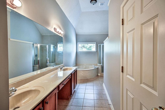 1563 Sutton Meadow Ln, Cordova, TN 38016 - full bathroom featuring double vanity, a stall shower, a garden tub, tile patterned floors, and a textured ceiling