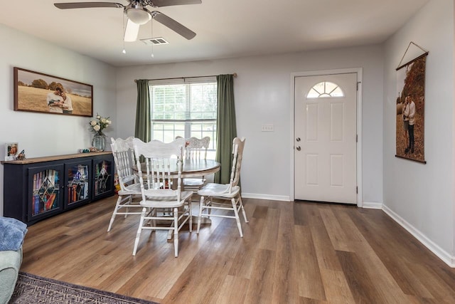 dining area featuring wood finished floors, ceiling fan, and baseboards