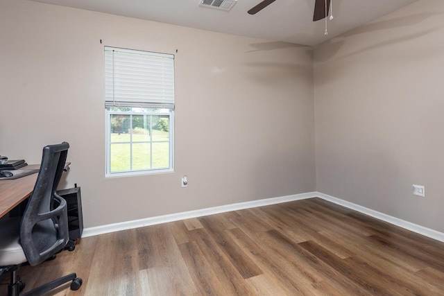 unfurnished office featuring wood finished floors, a ceiling fan, and baseboards