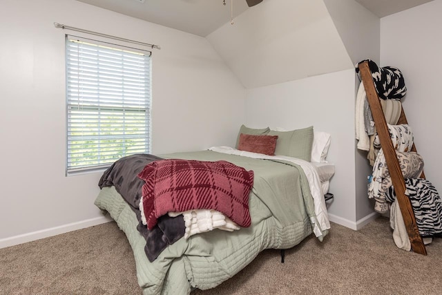 bedroom featuring carpet, vaulted ceiling, baseboards, and ceiling fan