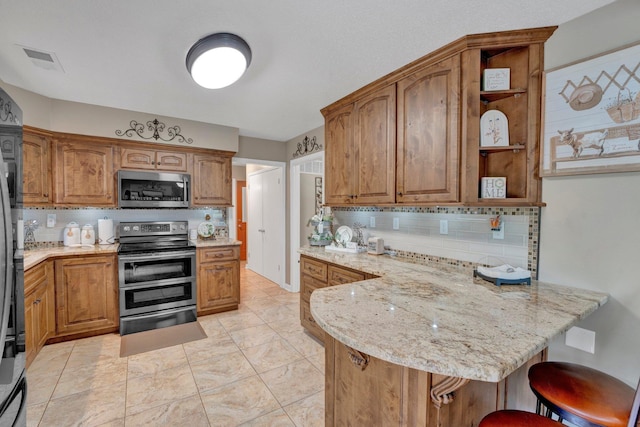 6331 Twin Oaks Dr, Millington, TN 38053 - kitchen featuring stainless steel appliances, a peninsula, open shelves, backsplash, and light stone countertops