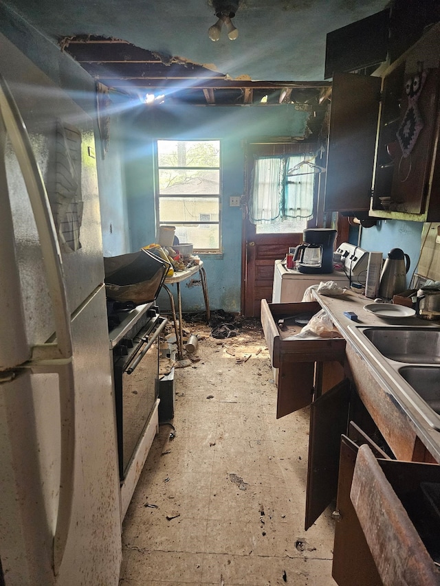 kitchen featuring gas stove and freestanding refrigerator