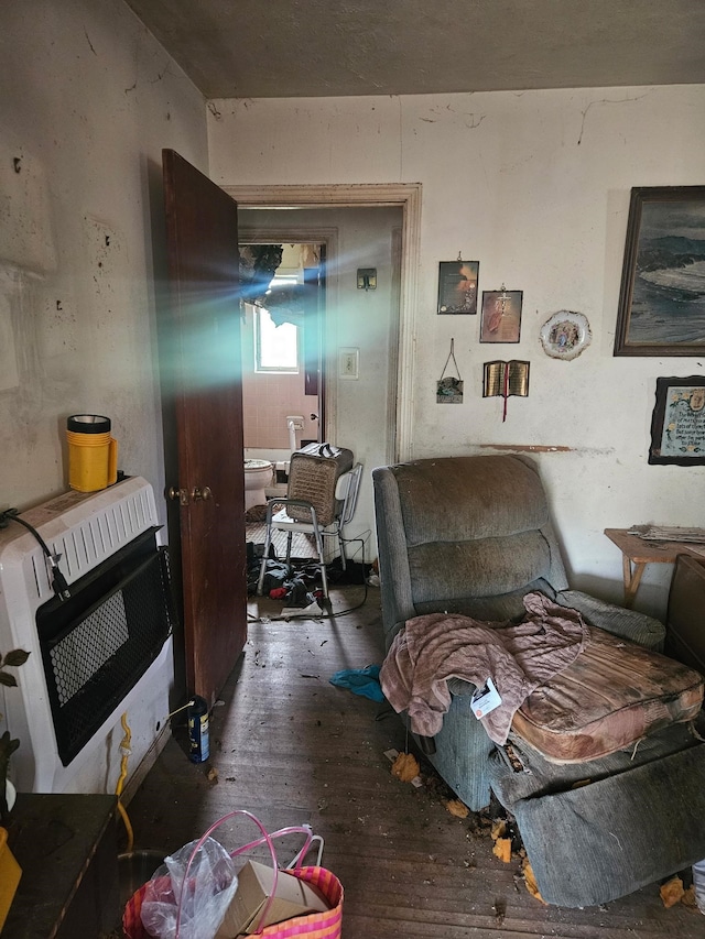 living room featuring heating unit and hardwood / wood-style flooring