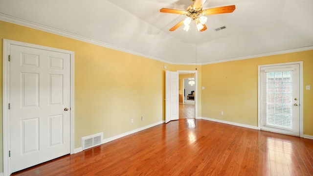 unfurnished room featuring a ceiling fan, wood finished floors, baseboards, and crown molding