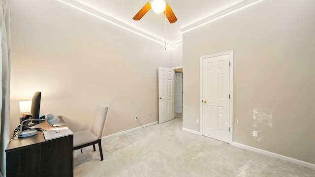 unfurnished office with light carpet, ceiling fan, and baseboards