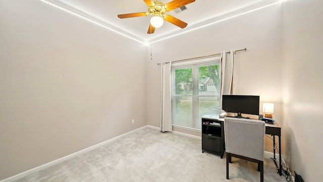 office space with ceiling fan, baseboards, and light carpet