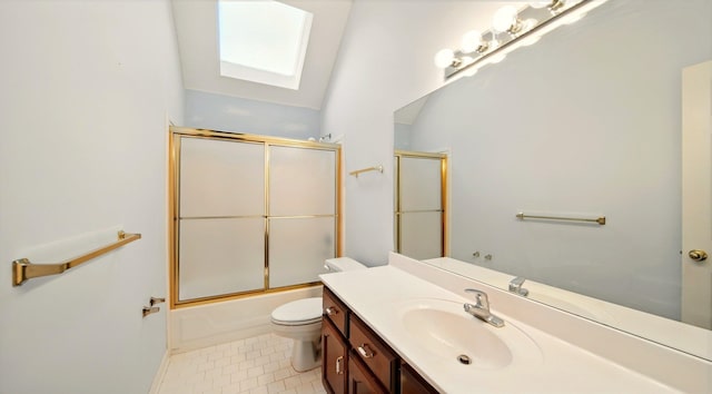 full bath with a skylight, toilet, vanity, and enclosed tub / shower combo
