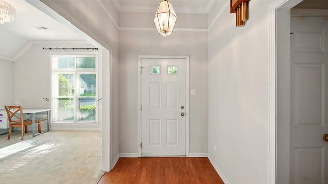 foyer entrance featuring light wood-style flooring, baseboards, and a chandelier