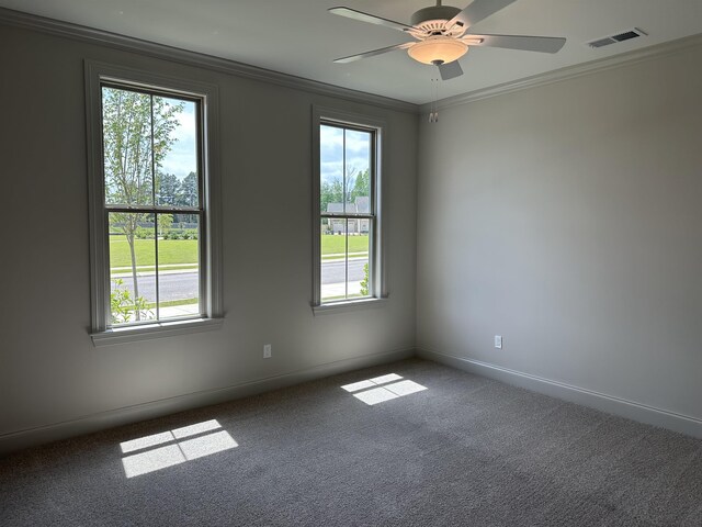 unfurnished room with ornamental molding, carpet floors, ceiling fan, and baseboards