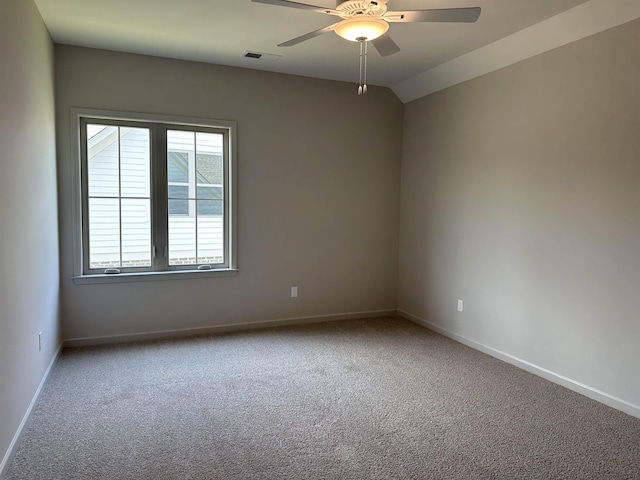spare room with carpet flooring, ceiling fan, and baseboards