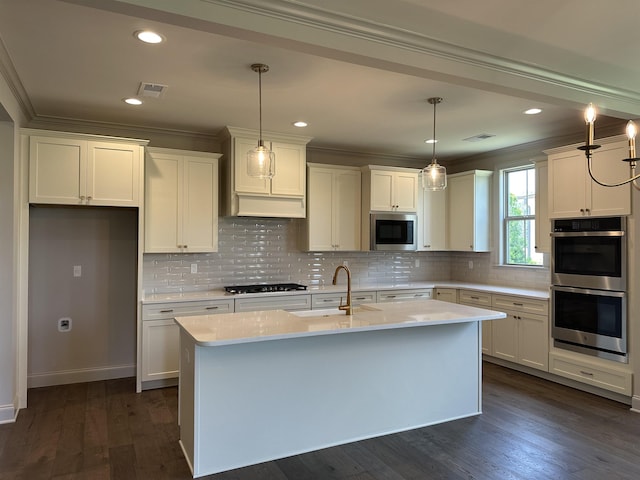 kitchen with stainless steel appliances, crown molding, an island with sink, white cabinetry, and recessed lighting