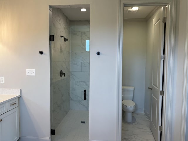 bathroom with marble look tiles, a shower stall, toilet, vanity, and baseboards